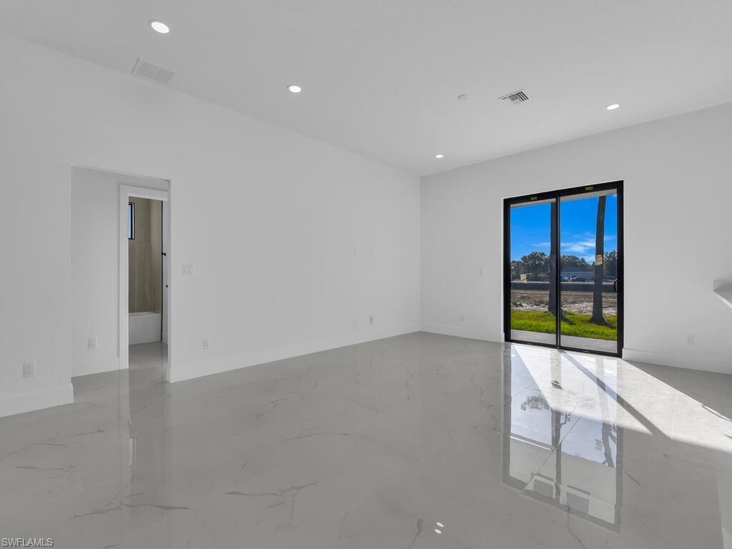 Unfurnished room with recessed lighting and light marble finish floors