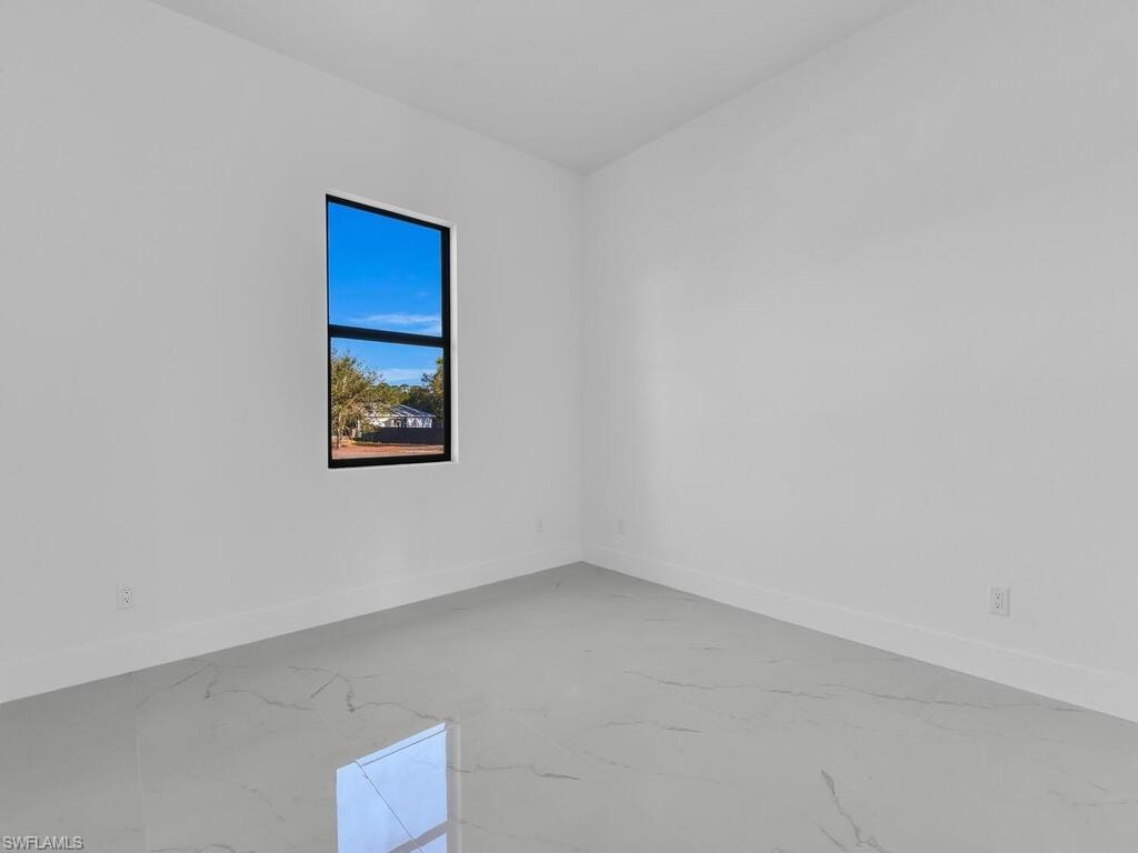 Spare room featuring baseboards