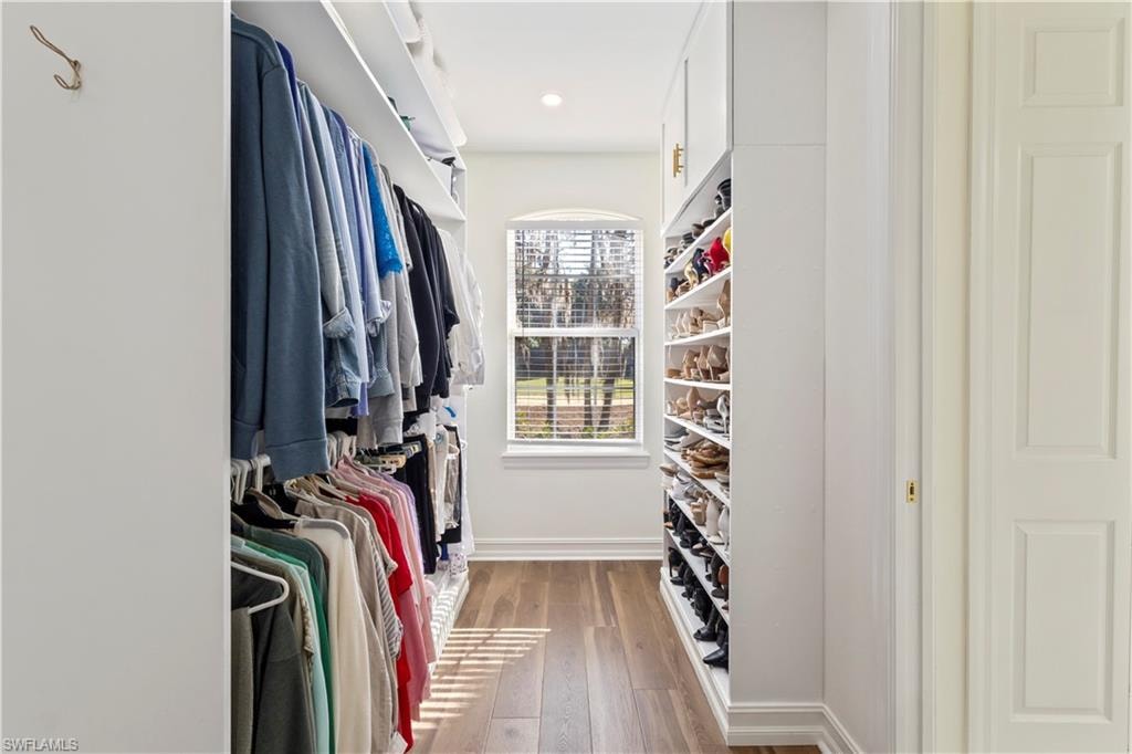 Walk in closet featuring light wood-style floors