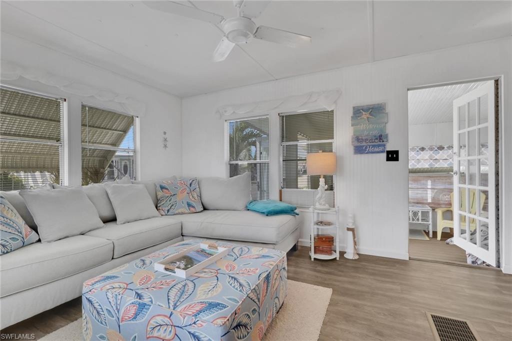 Living room featuring a ceiling fan and wood finished floors