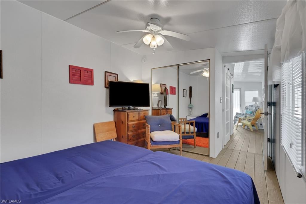 Bedroom featuring hardwood / wood-style flooring, a ceiling fan, and a closet