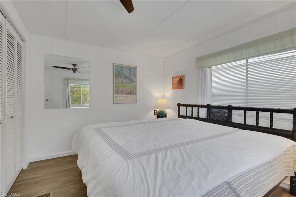 Bedroom featuring wood finished floors, a ceiling fan, and a closet