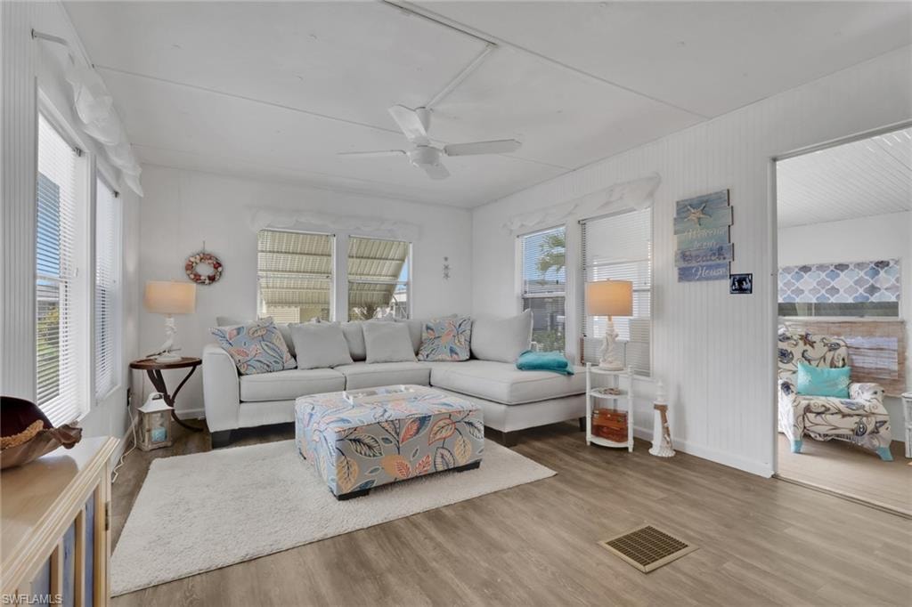 Living room with wood finished floors and ceiling fan