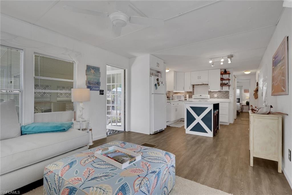 Living area with light wood-style flooring and ceiling fan