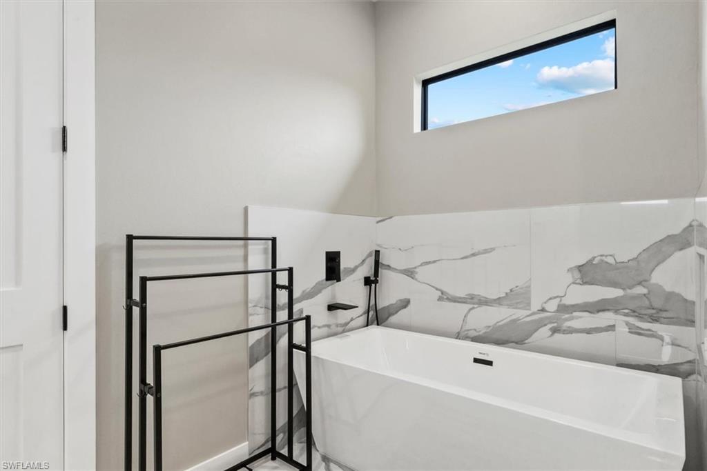 Full bathroom with a soaking tub