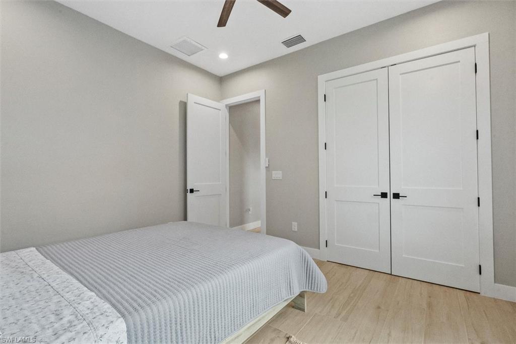 Bedroom featuring light wood-type flooring, ceiling fan, a closet, and recessed lighting