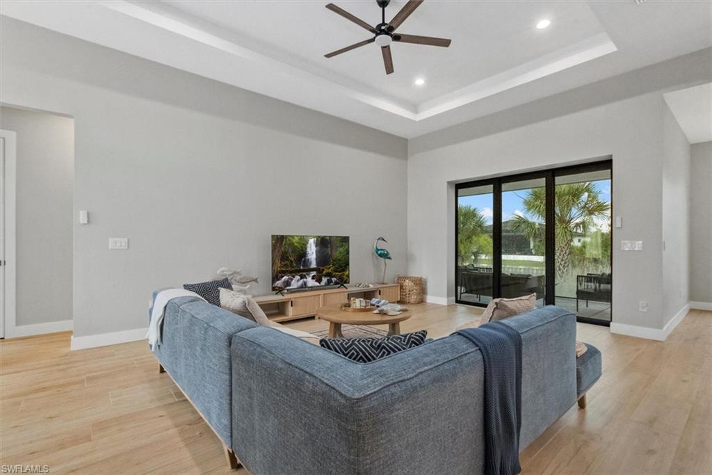 Living area featuring a ceiling fan, light wood-style flooring, and recessed lighting