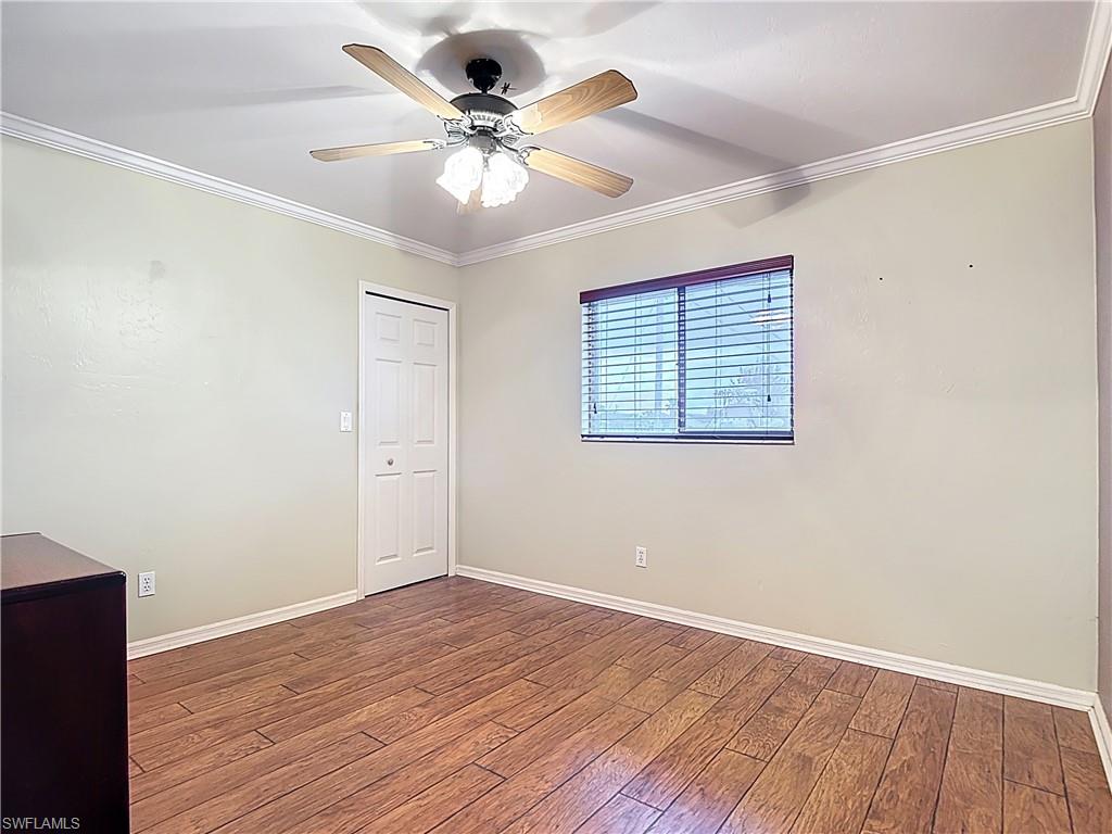 Spare room featuring a ceiling fan, ornamental molding, and hardwood / wood-style flooring