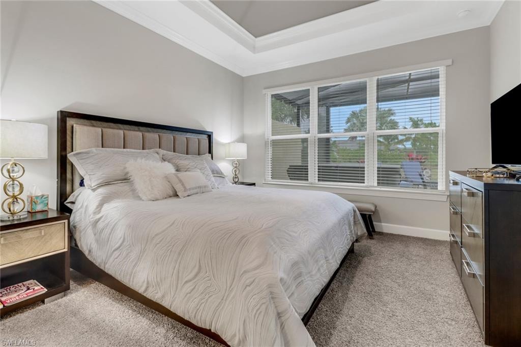 Bedroom with light carpet and ornamental molding
