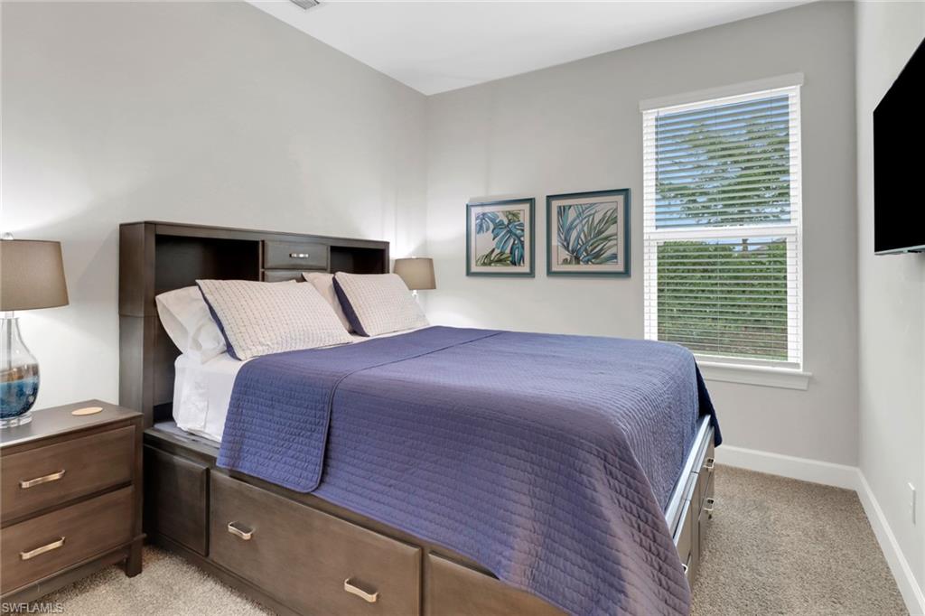 Bedroom with light carpet and baseboards