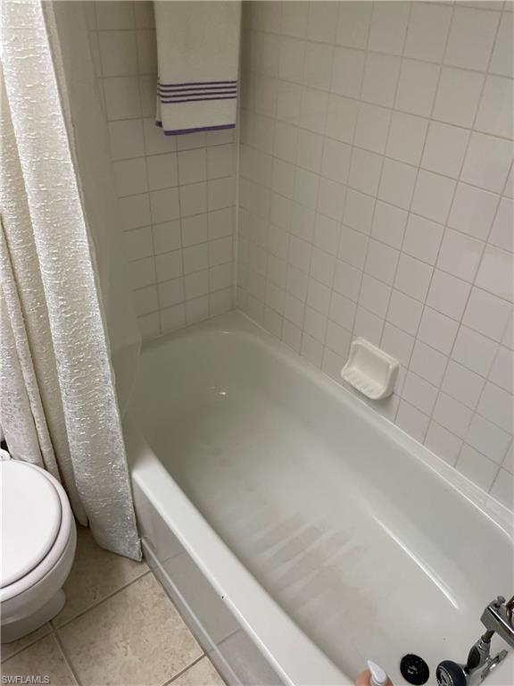 Bathroom featuring tile patterned flooring and shower / tub combo