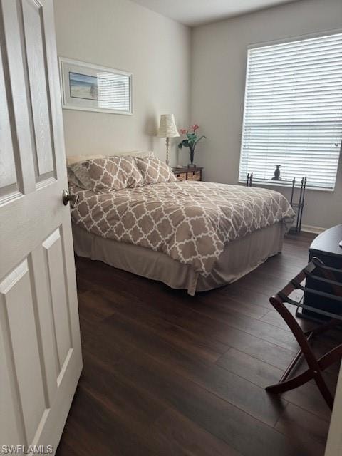 Bedroom with dark wood-style floors