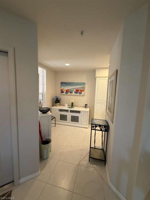 Corridor with baseboards and recessed lighting