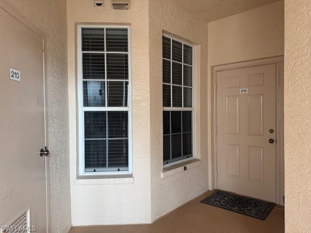 View of exterior entry with stucco siding