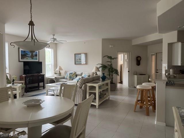 Dining room with ceiling fan and light tile patterned floors