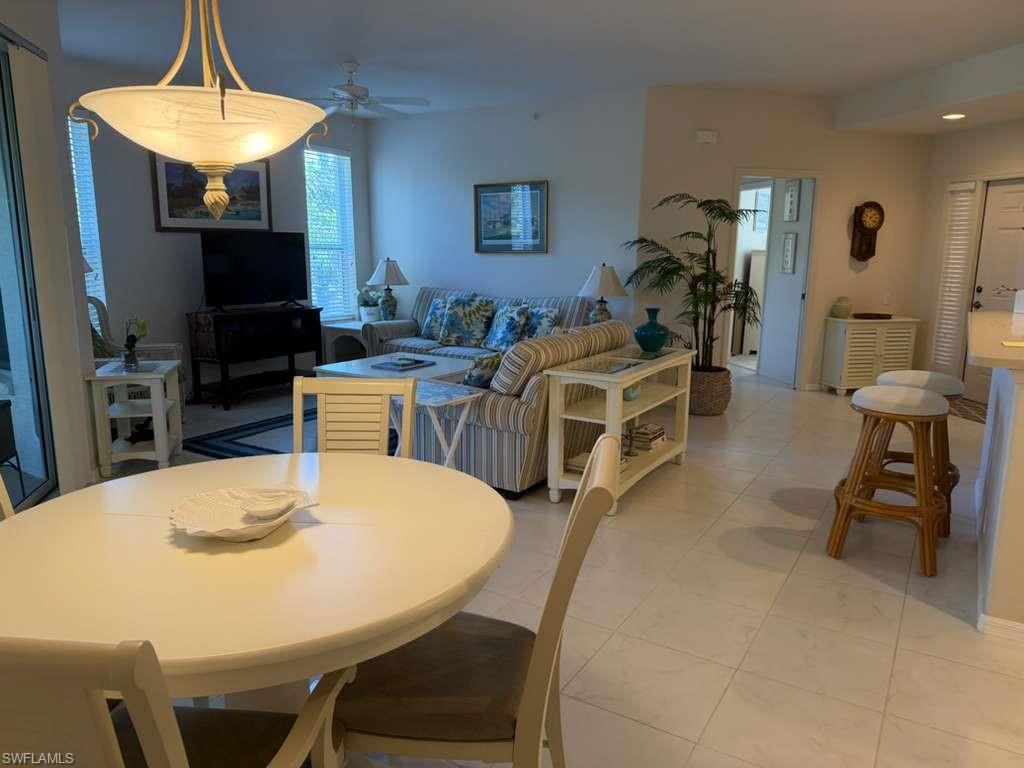Dining space featuring ceiling fan and light tile patterned floors