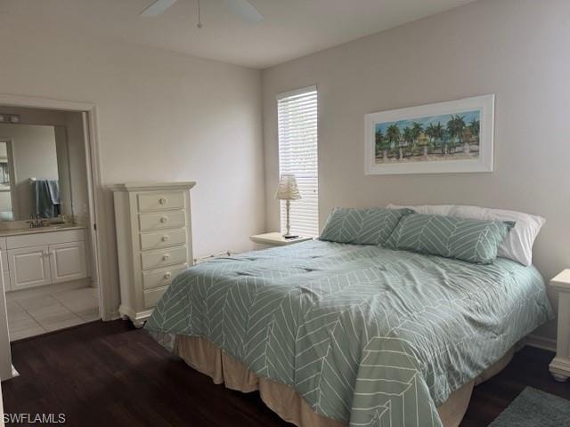 Bedroom featuring dark wood-style flooring, ceiling fan, and connected bathroom