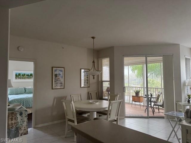 Dining room with baseboards and light tile patterned flooring