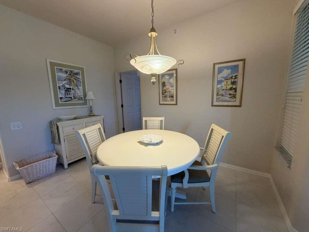 Dining space featuring light tile patterned floors