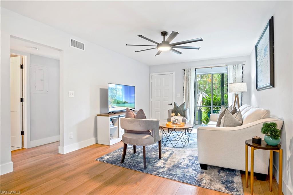 Living area featuring light wood-style flooring and a ceiling fan