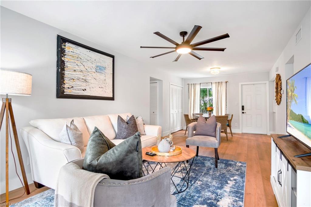 Living area with ceiling fan and light wood-style floors