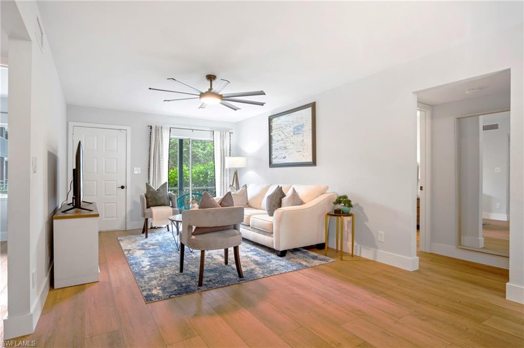 Living area with light wood finished floors and a ceiling fan