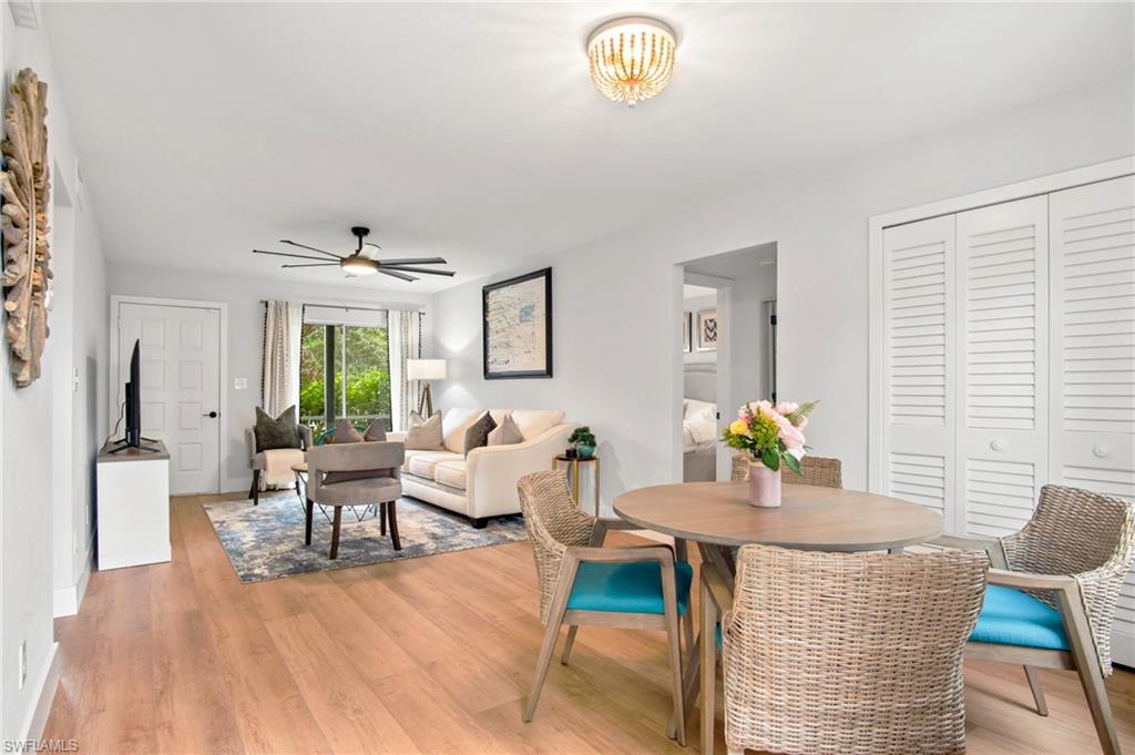Dining area with light wood-style flooring and ceiling fan