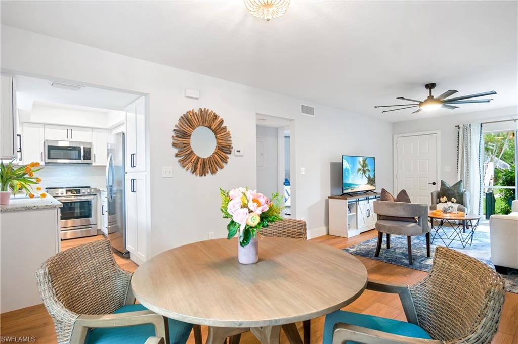 Dining room with light wood-style flooring and a ceiling fan