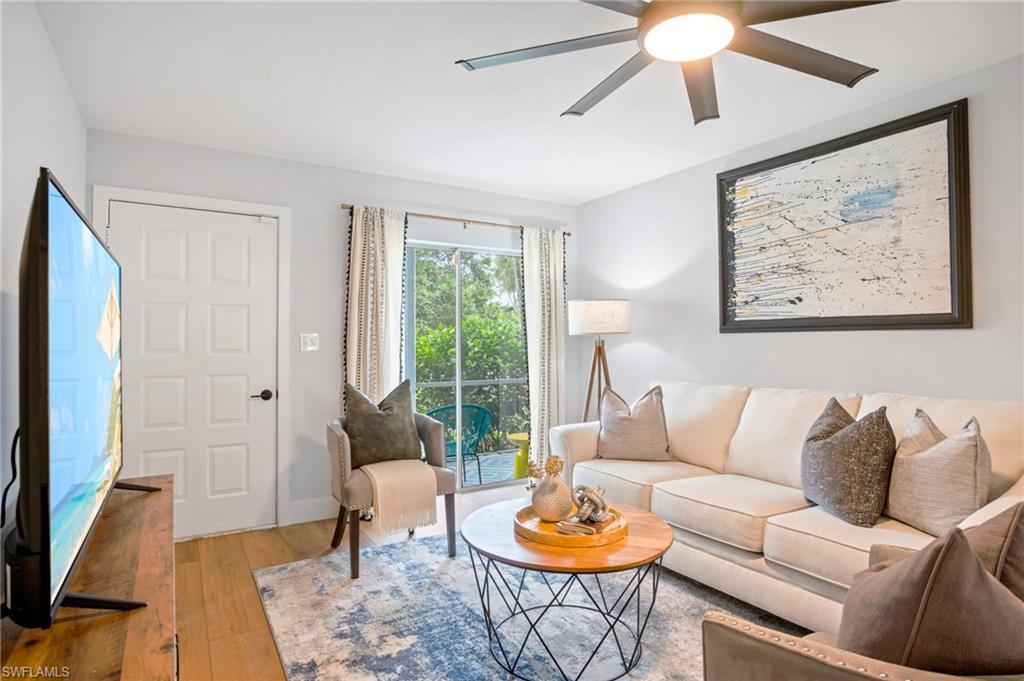 Living area featuring hardwood / wood-style floors and a ceiling fan