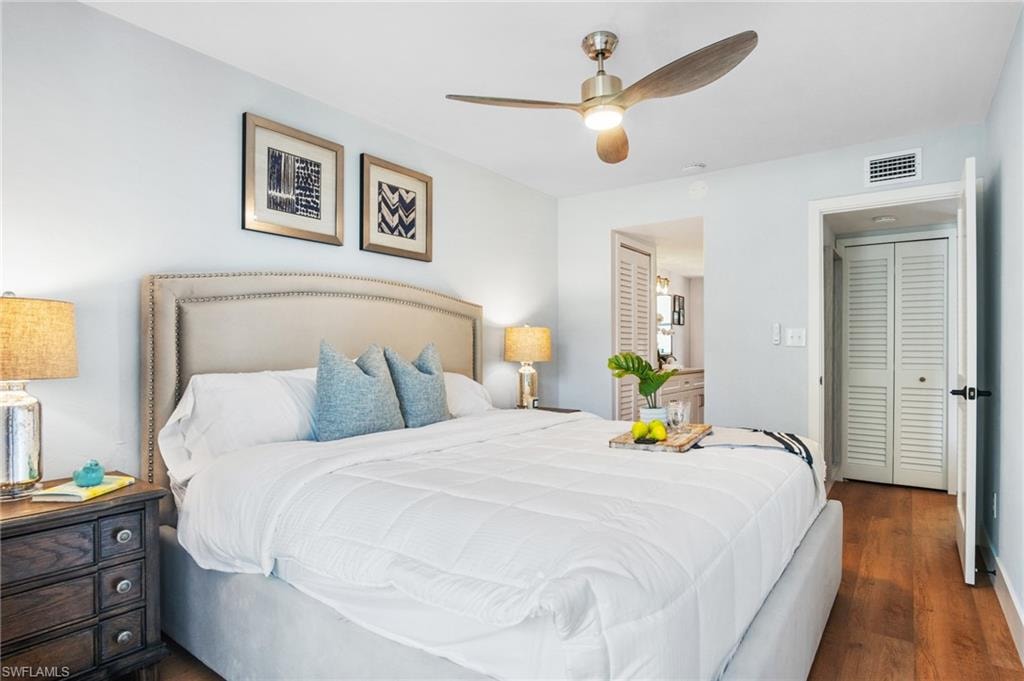 Bedroom with dark wood-style floors and ceiling fan
