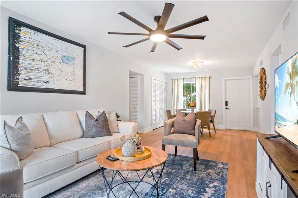 Living area with light wood-style flooring and ceiling fan