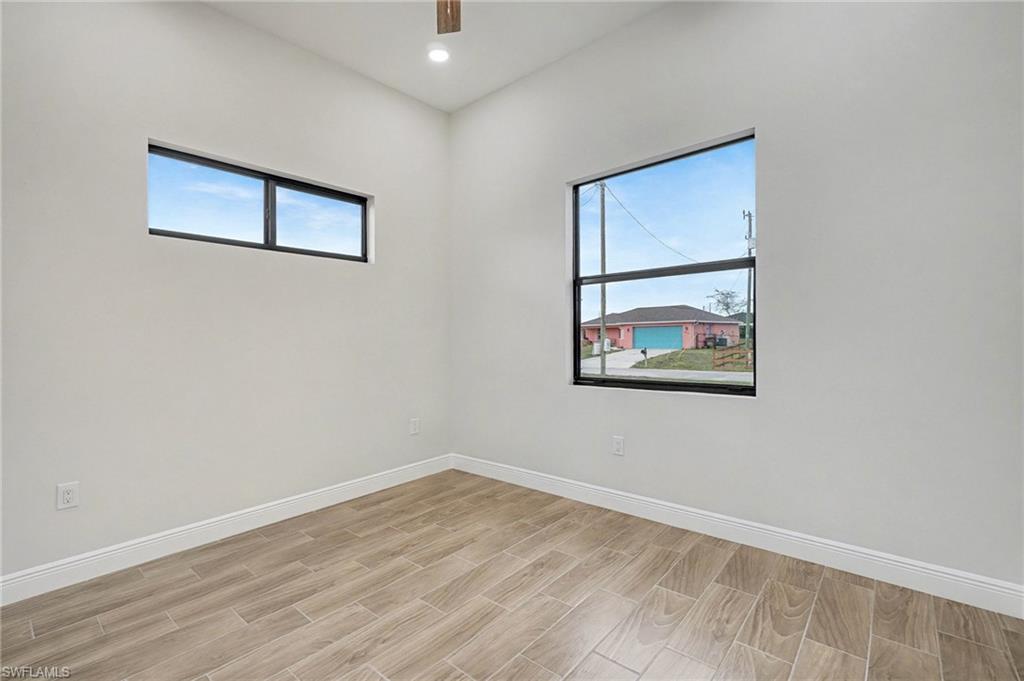 Spare room with wood tiled floors and recessed lighting
