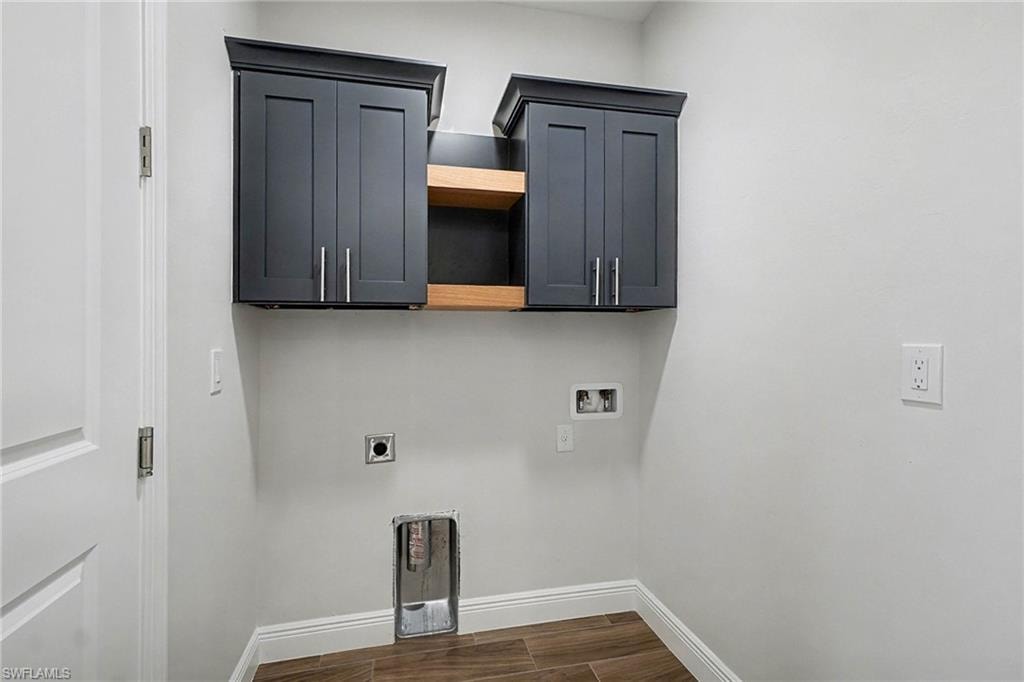 Laundry room with cabinet space, wood finish floors, electric dryer hookup, and hookup for a washing machine