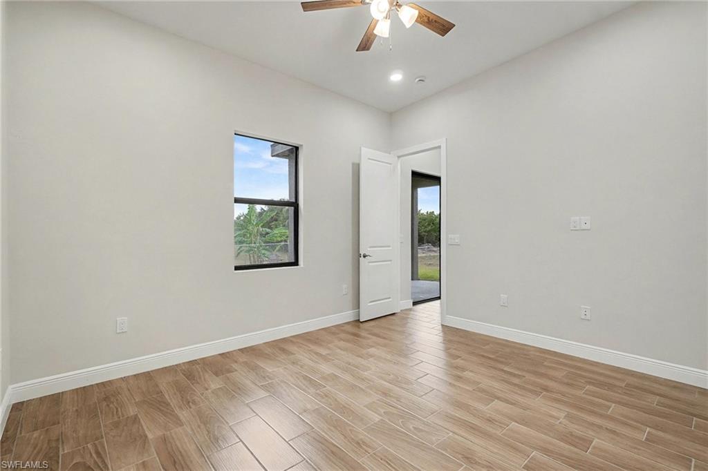Spare room with wood finish floors, ceiling fan, and recessed lighting