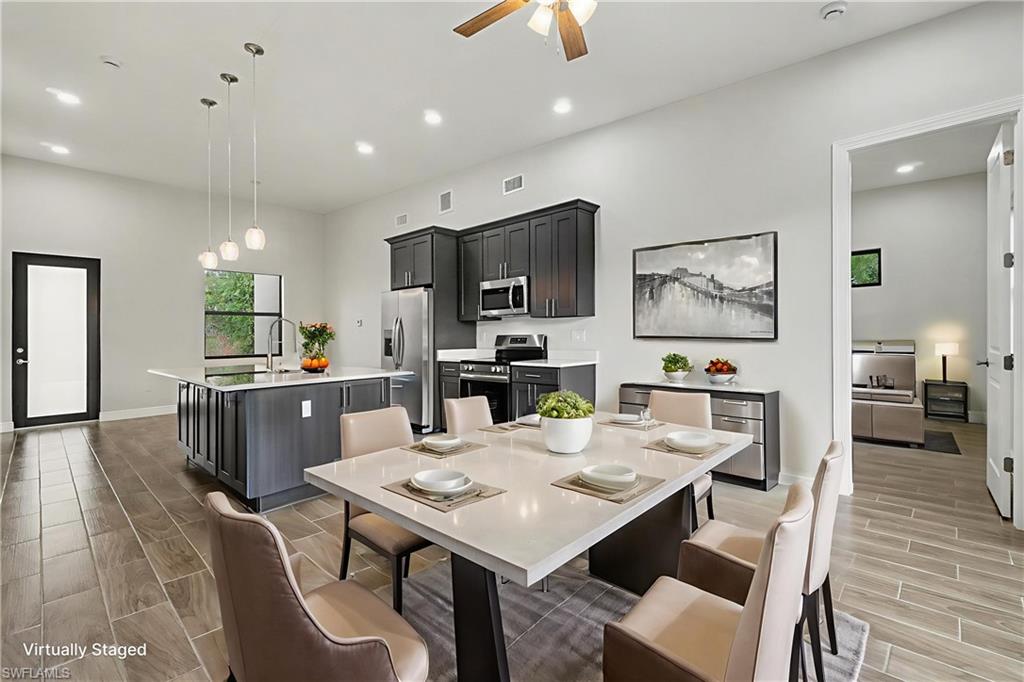 Dining space featuring wood finish floors, a ceiling fan, and recessed lighting