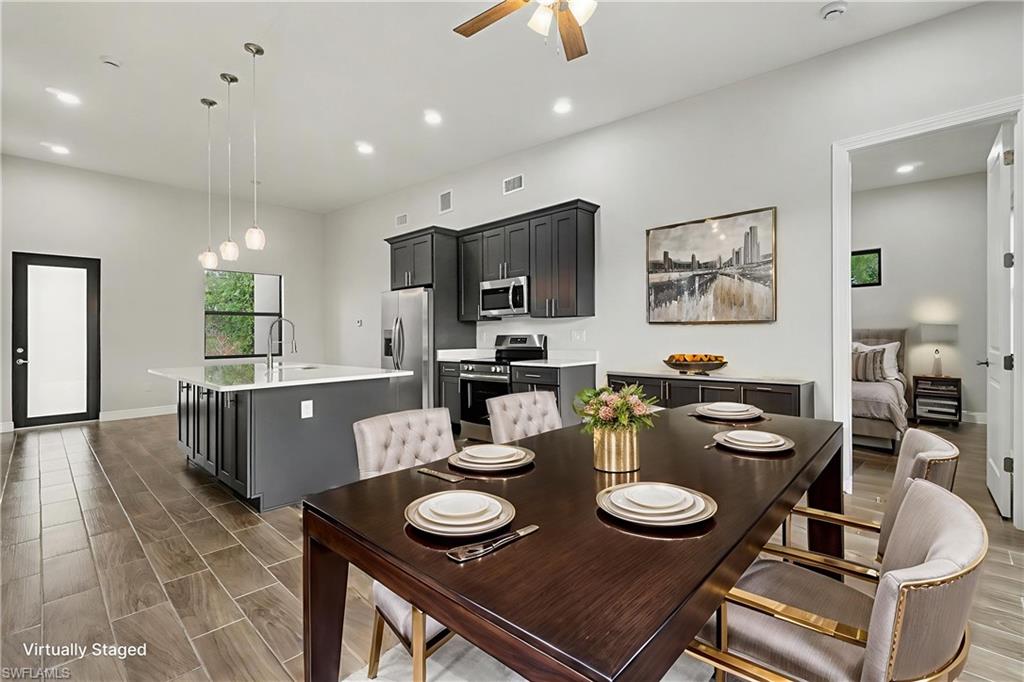 Dining room featuring wood tiled floors, a ceiling fan, and recessed lighting