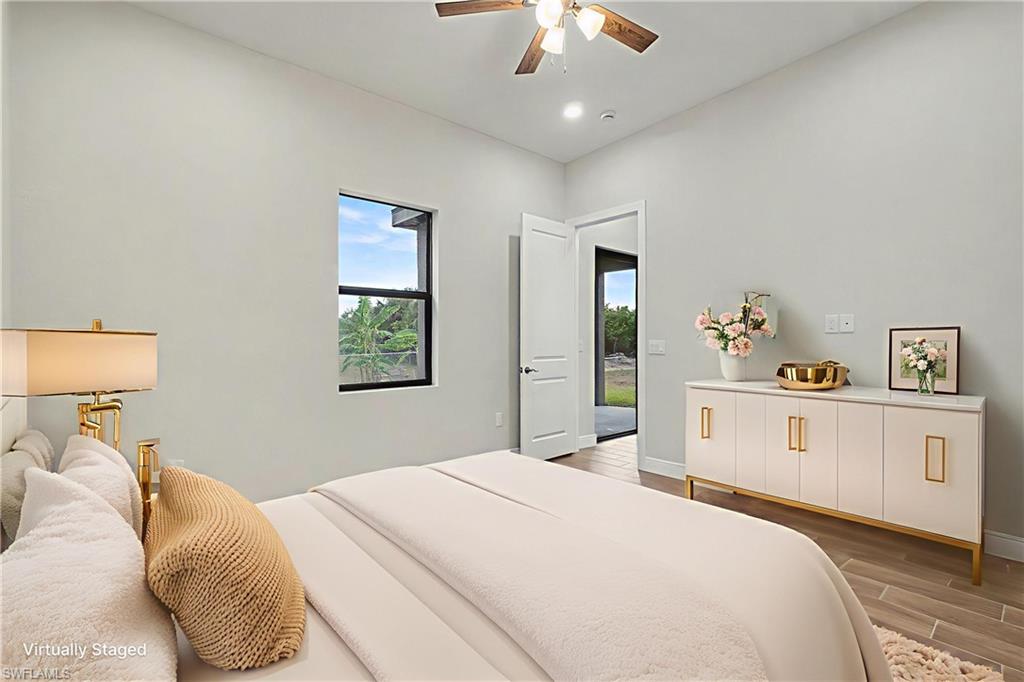 Bedroom featuring wood tiled floors and ceiling fan