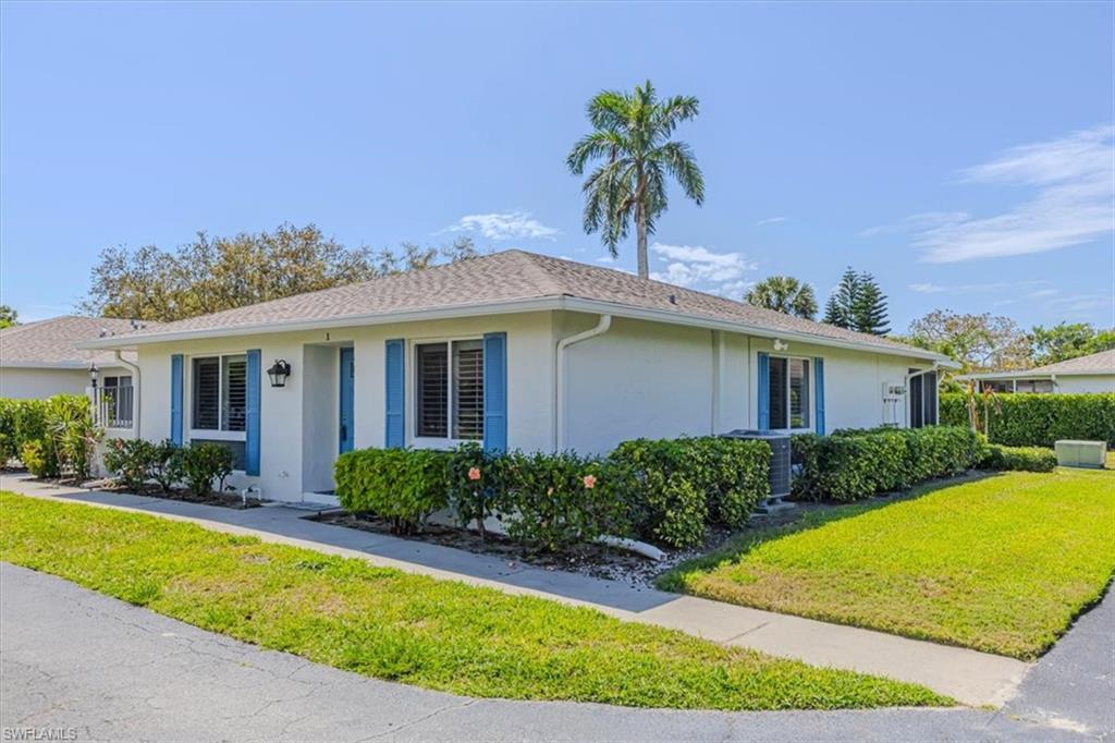 Property entrance featuring front and side yard