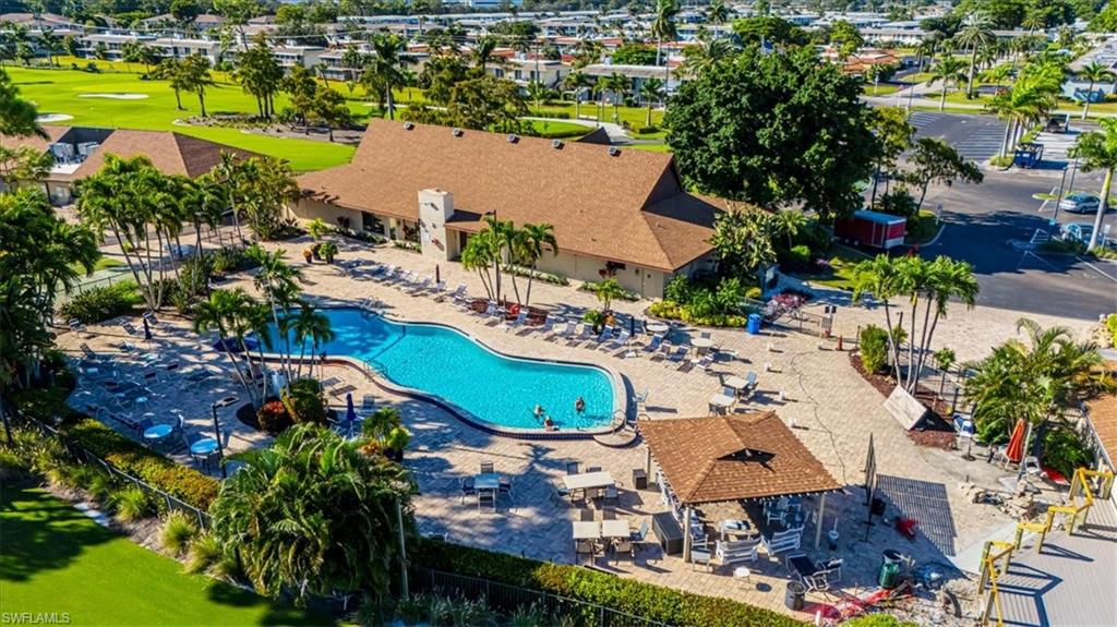 Community pool with a patio and golf course view
