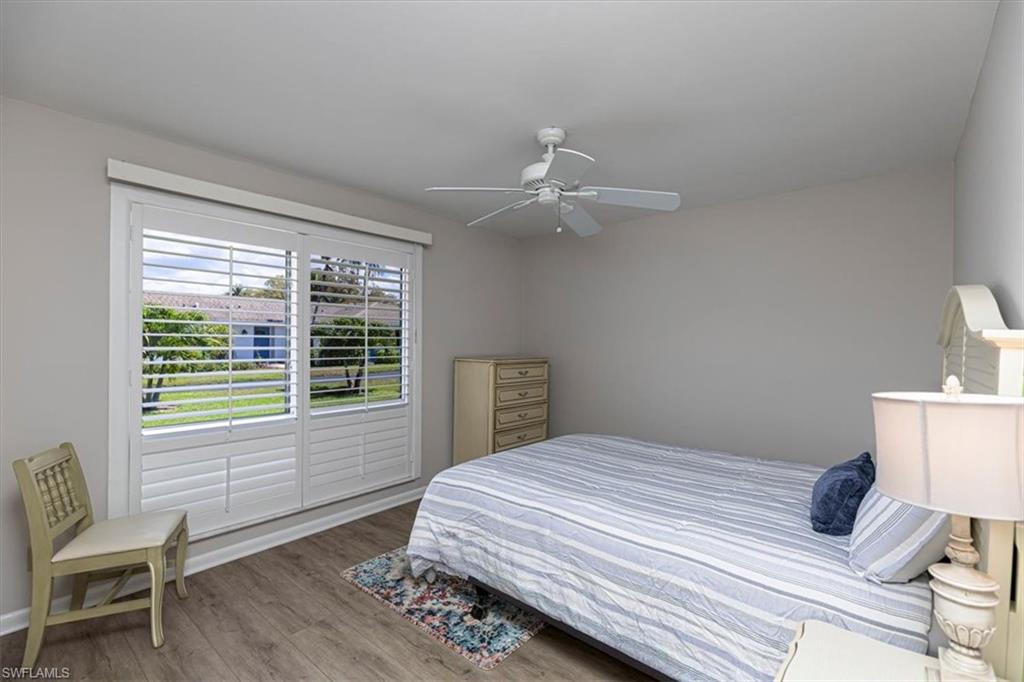 Guest Bedroom with light wood-style floors and ceiling fan