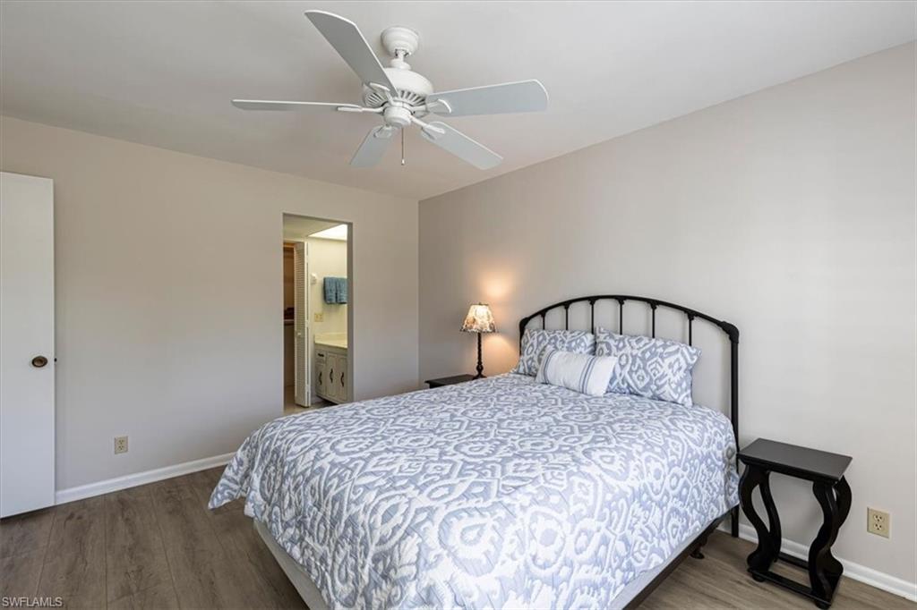 Primary Bedroom with light wood-style flooring, a ceiling fan, and ensuite bathroom