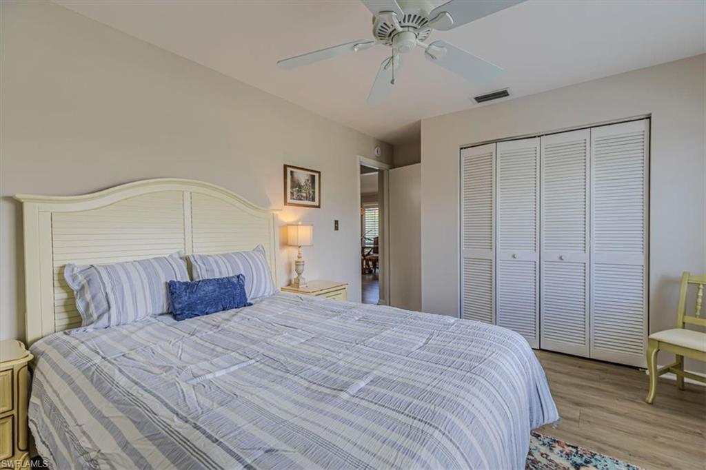 Guest Bedroom with ceiling fan, light wood-style floors, and a closet