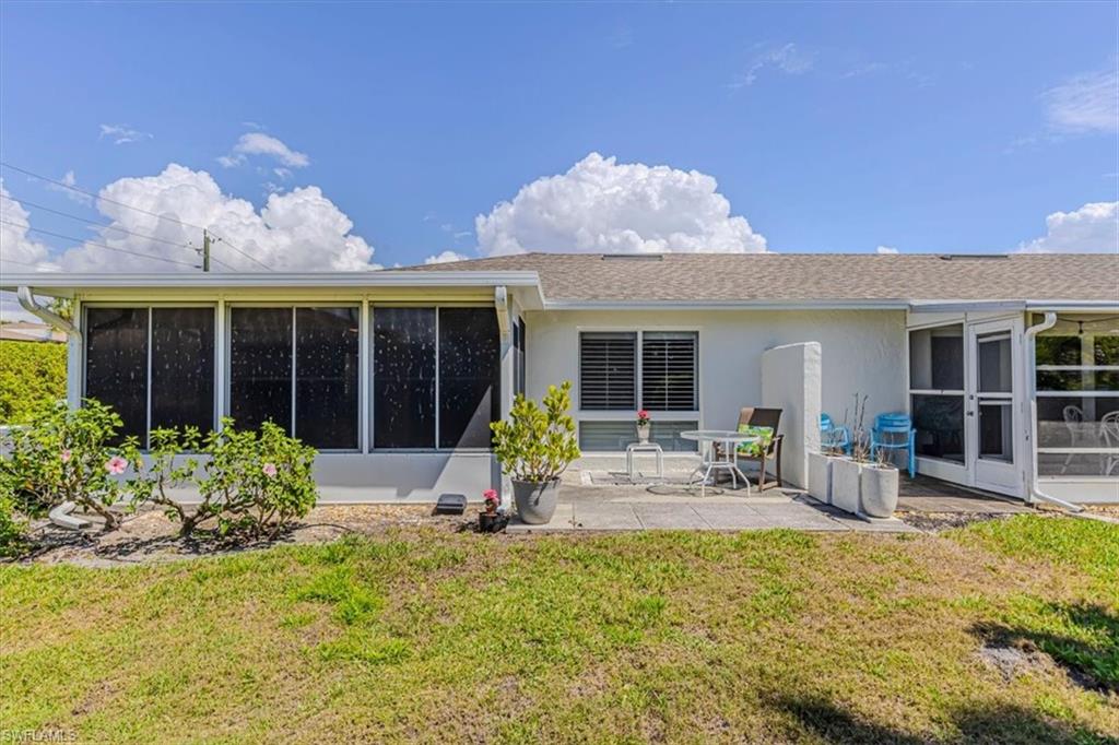 Back of property featuring lanai, the patio area and yard