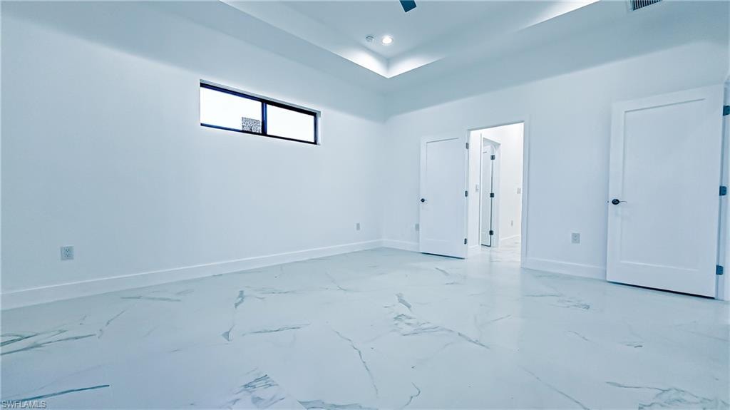 Unfurnished bedroom featuring baseboards and ceiling fan