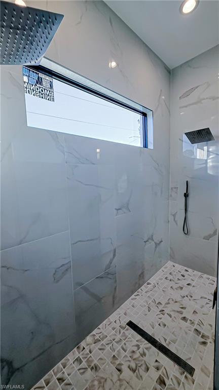 Full bath featuring a marble finish shower