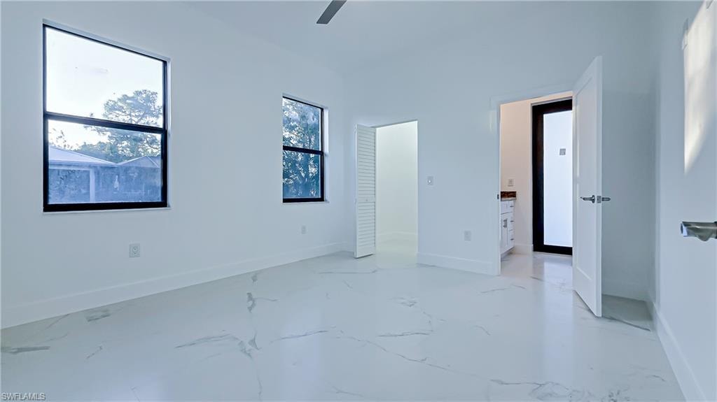 Unfurnished bedroom with baseboards and ceiling fan