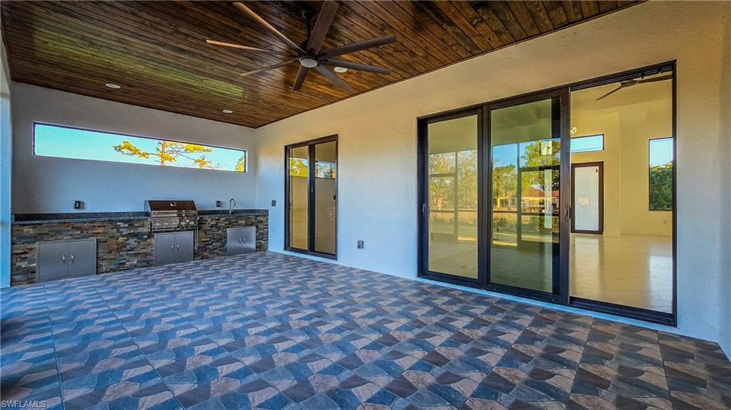 View of patio featuring a ceiling fan and exterior kitchen