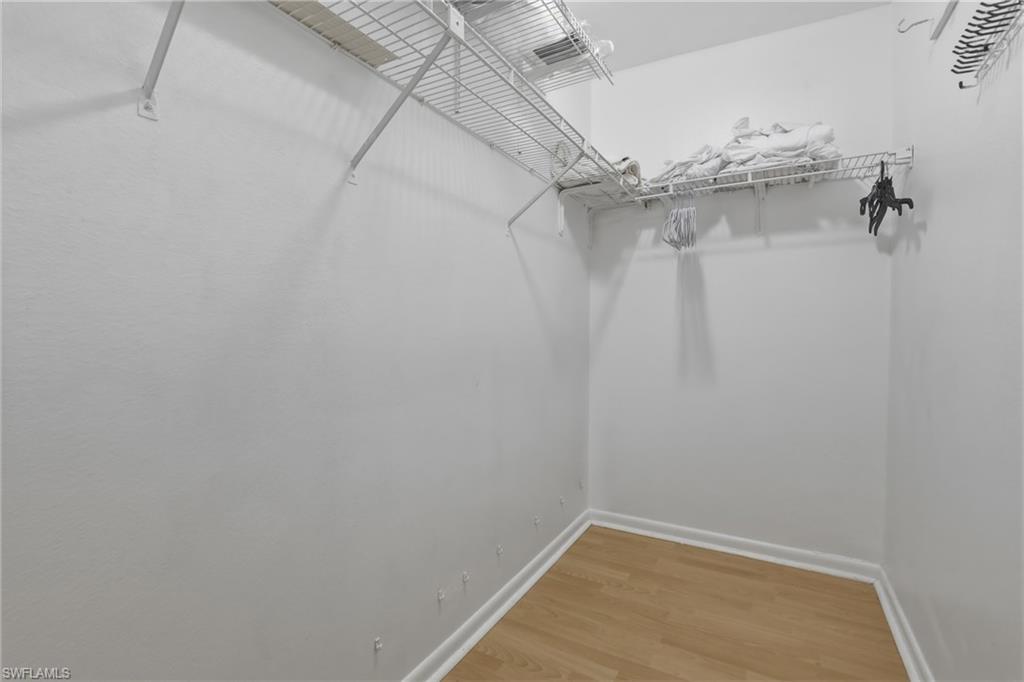 Walk in closet featuring wood finished floors
