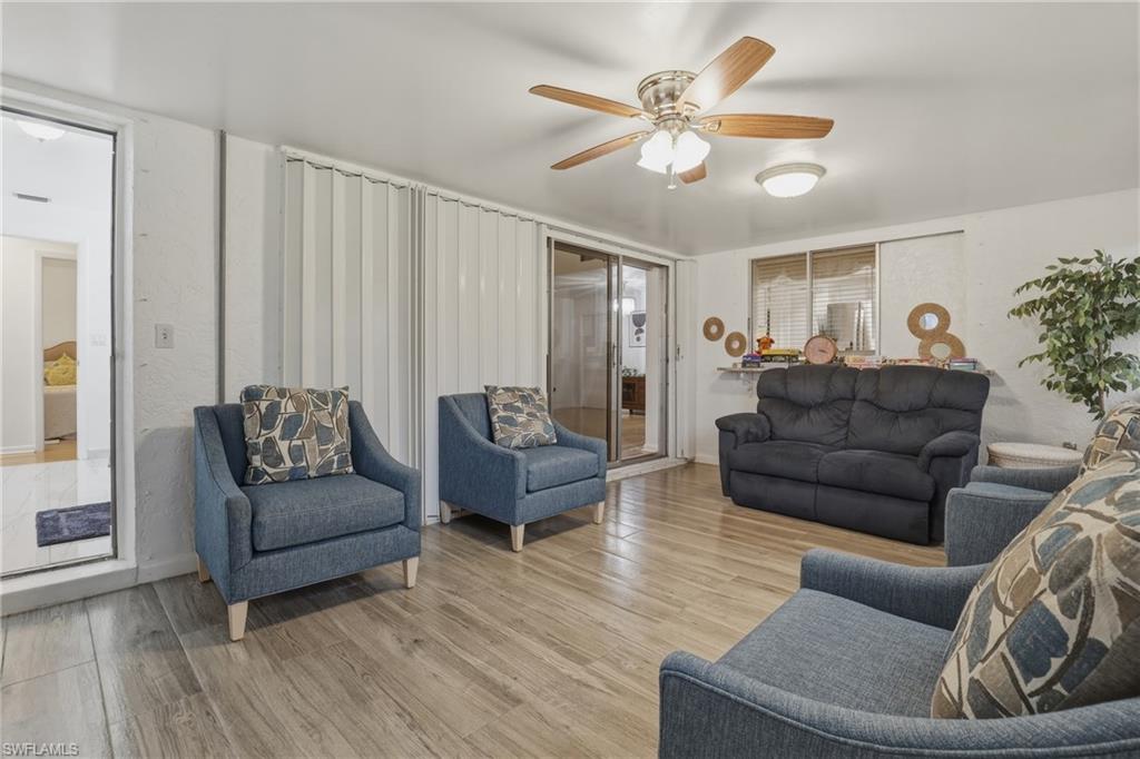 Living area featuring ceiling fan and wood finished floors