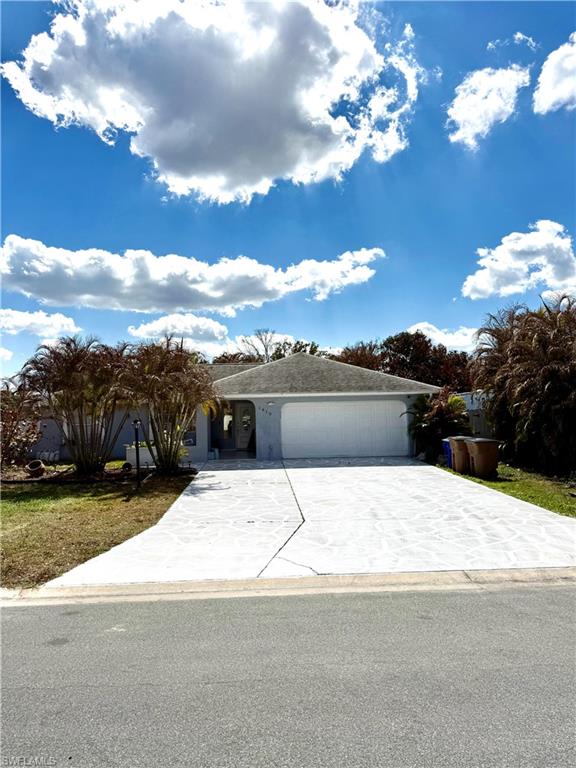 Ranch-style house with a garage and driveway